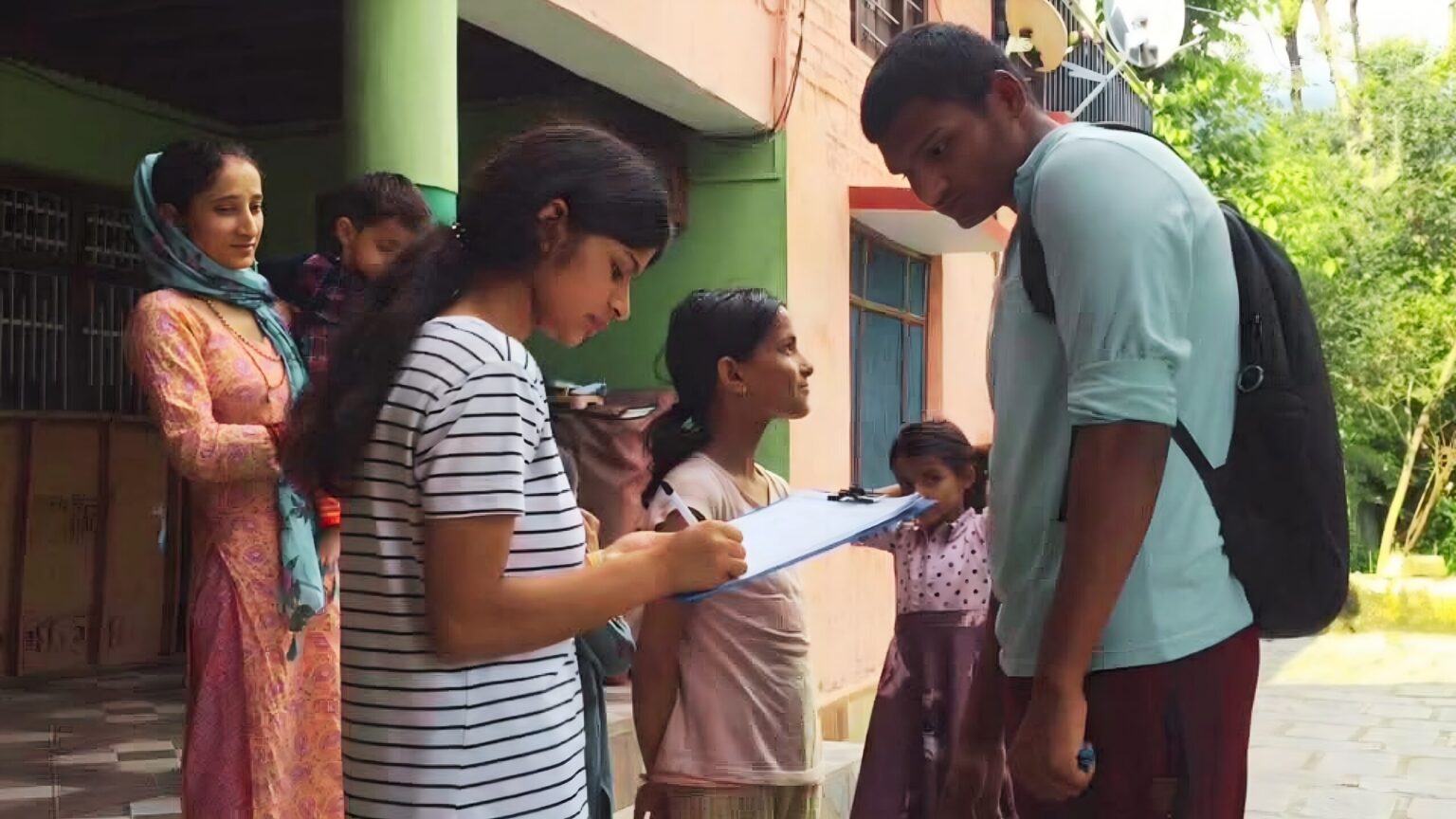 An EIF young female community leader from Mohli village gathering grassroots field research during a pilot community survey in Rakkar village.