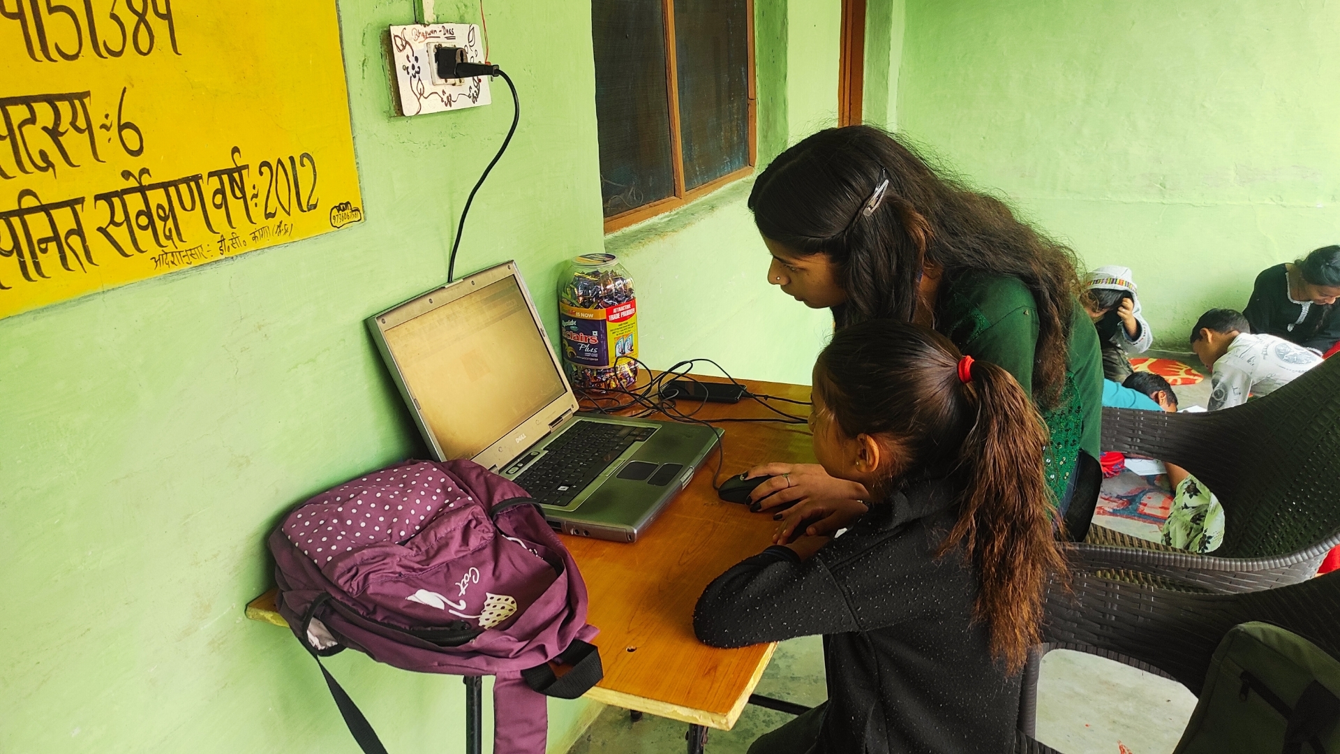 Youth leaders teaching fundamental computer science in village