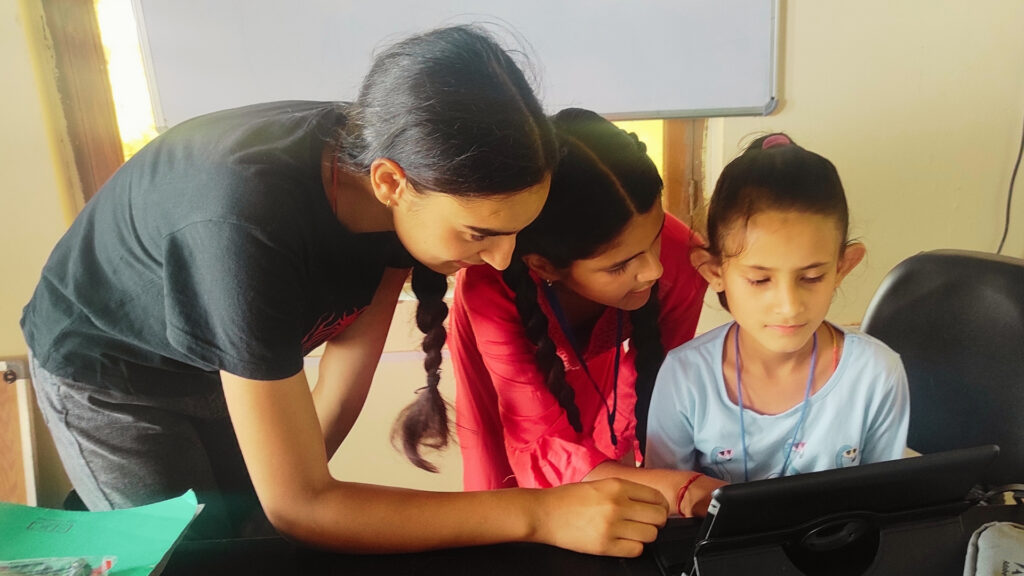Village leader teaching basic coding to young girl