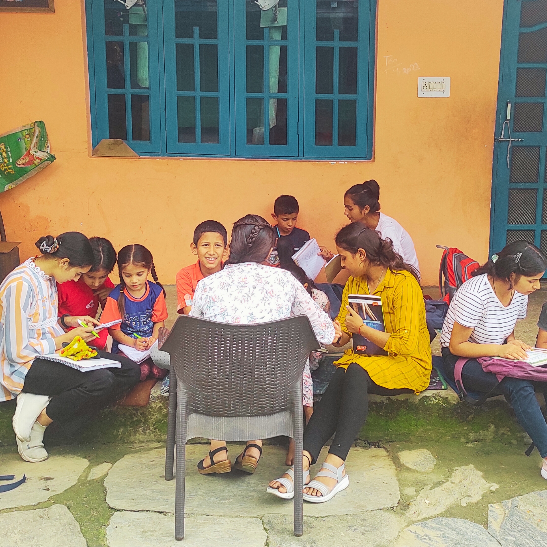 EIF female community leaders assessing grassroots educational needs by interacting with children in Slate Godam village, Dharamshala, to inform the Adaptive Skills Framework.