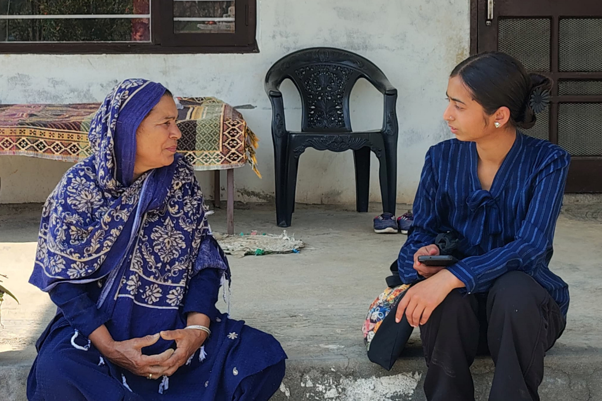An EIF project coordinator gathering ground-level research by conducting a rural women's survey with a local woman in Chamotu village in Dharamshala