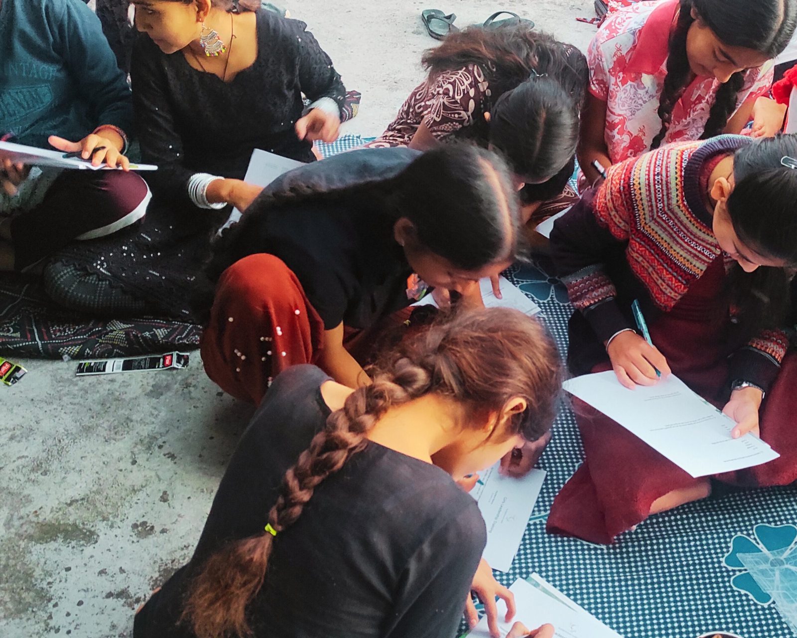 Young rural girls in Mohli village completing research surveys for the Evidence and Insights Unit.